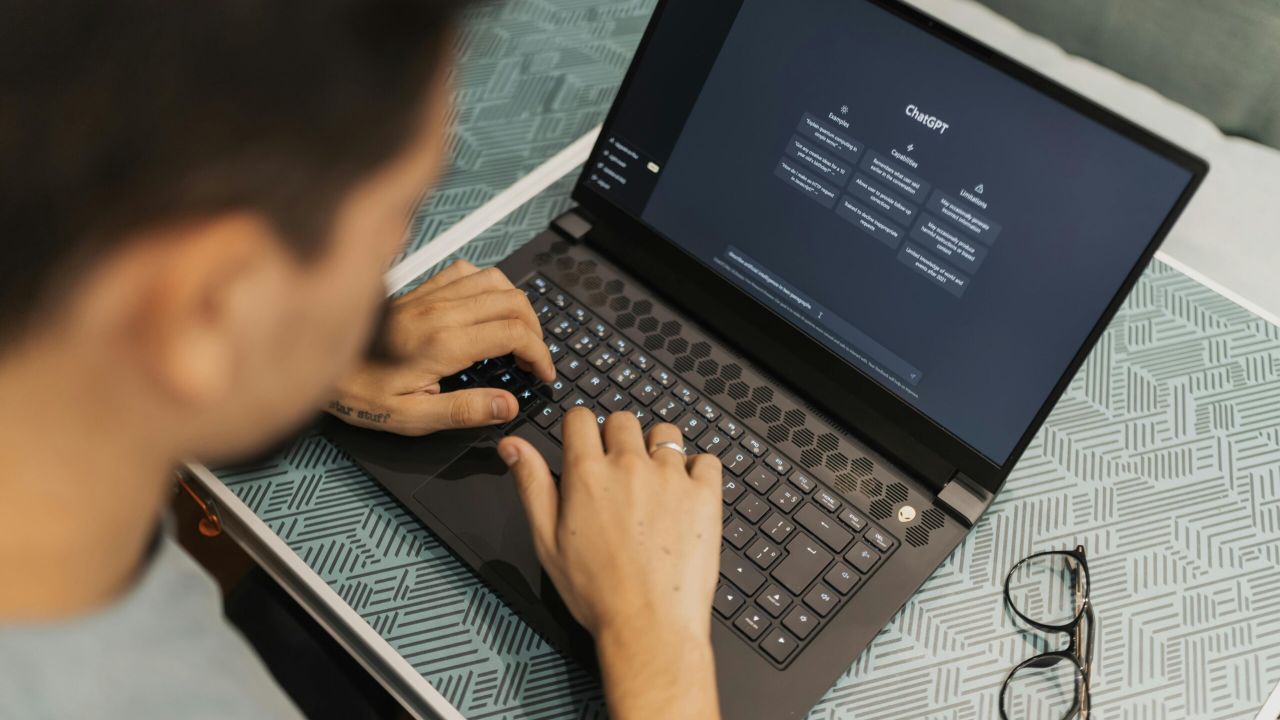 Person at a laptop with ChatGPT on the screen