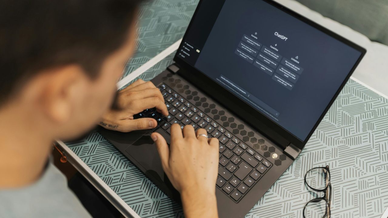 Person at a laptop with ChatGPT on the screen